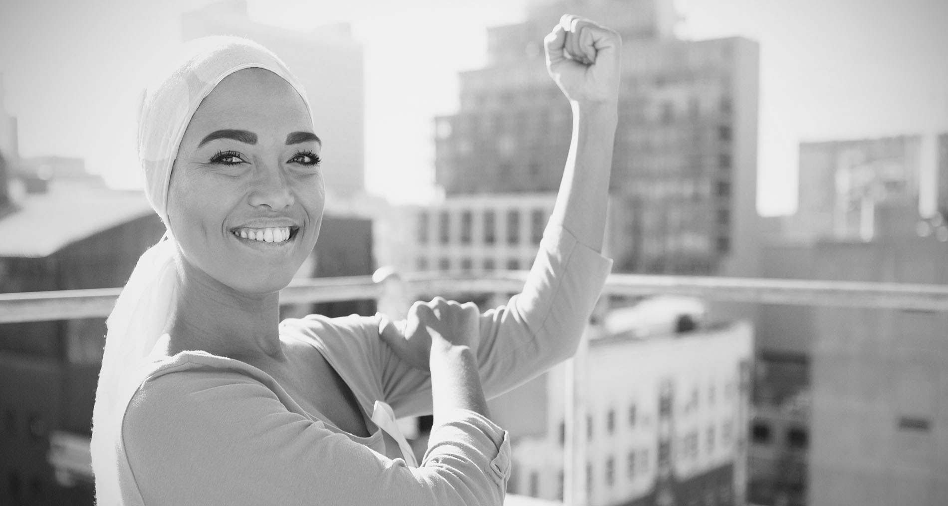 Strong woman in city with breast cancer awareness
